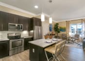 Thumbnail 8 of 52 - a kitchen with stainless steel appliances and a marble counter top at Aster Apartments, Beachwood, OH 44122