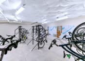 Thumbnail 24 of 52 - a room filled with bikes and paintings on the wall at Aster Apartments, Ohio, 44122
