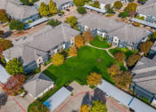 Thumbnail 44 of 51 - Aerial view of a neighborhood with houses and a green lawn at Riachi at One21, Texas, 75025