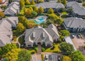 Thumbnail 33 of 51 - Aerial view of a neighborhood with houses and a swimming pool at Riachi at One21, Plano