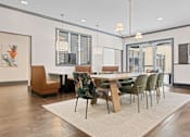 Thumbnail 2 of 52 - A dining room with a table surrounded by chairs at Aster Apartments, Beachwood, OH