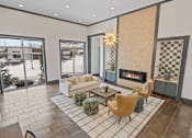 Thumbnail 49 of 52 - A living room with a fireplace and a large window at Aster Apartments, Ohio, 44122