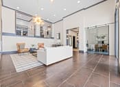 Thumbnail 48 of 52 - A spacious living room with a white sofa and wooden chairs at Aster Apartments, Beachwood