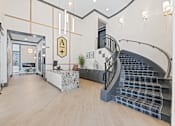Thumbnail 47 of 52 - A modern interior with a staircase and a reception desk at Aster Apartments, Beachwood