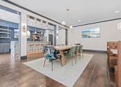 Thumbnail 44 of 52 - A modern dining room with a wooden table and chairs at Aster Apartments, Beachwood Ohio