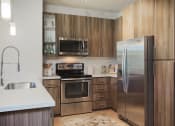 Thumbnail 35 of 48 - Chef-Inspired Kitchens Feature Stainless Steel Appliances at Audere Apartments, Phoenix, 85016
