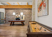 Thumbnail 6 of 56 - A billiard table is in the middle of a room with a brick wall and a bench.