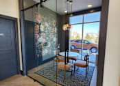 Thumbnail 50 of 52 - A glass door with a black frame leads to a balcony with a table and chairs at Aster Apartments, Ohio