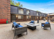 Thumbnail 9 of 28 - a patio with furniture and a fire pit at Park 44, St. Louis, MO, 63108
