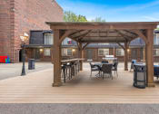 Thumbnail 26 of 28 - a patio with tables and chairs and a pergola at Park 44, St. Louis, MO, 63108