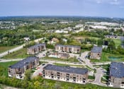 Thumbnail 36 of 36 - an aerial view of a city with several apartment buildings and a lake at Statesman Apartments, Franklin, Wisconsin