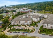Thumbnail 62 of 63 - an aerial view of an apartment complex with cars parked in a parking lot at Vanguard Crossing, St. Louis, Missouri