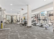 Thumbnail 4 of 52 - A gym with a variety of exercise equipment and a treadmill at Aster Apartments, Ohio, 44122