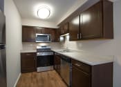 Thumbnail 23 of 37 - Espresso Cabinets with Stainless Steel Appliances in Kitchens at The Greenway at Carol Stream, Carol Stream, Illinois 60188