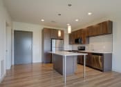 Thumbnail 13 of 36 - a kitchen with stainless steel appliances and a white counter top at Statesman Apartments, Franklin, 53132
