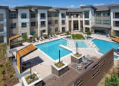 Thumbnail 7 of 40 - an aerial view of an apartment building with a swimming pool at Hunters Creek Apartments, Denton, 76210