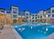 Thumbnail 12 of 40 - a large swimming pool in front of an apartment building at Hunters Creek Apartments, Texas