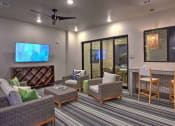 Thumbnail 17 of 40 - a living room with a table and chairs and a television at Hunters Creek Apartments, Texas, 76210