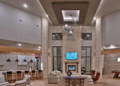Thumbnail 18 of 40 - a lobby with a lot of furniture and a tv at Hunters Creek Apartments, Denton, TX 76210