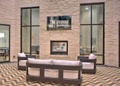 Thumbnail 19 of 40 - a room with a couch and a wall with a geometric design at Hunters Creek Apartments, Denton Texas
