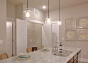Thumbnail 33 of 40 - a kitchen with a sink and a counter top at Hunters Creek Apartments, Denton Texas