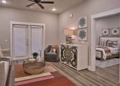 Thumbnail 34 of 40 - a living room with furniture and a ceiling fan at Hunters Creek Apartments, Denton