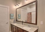 Thumbnail 35 of 40 - a bathroom with a sink and a mirror at Hunters Creek Apartments, Denton, TX 76210