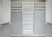 Thumbnail 29 of 69 - A white shelving unit with multiple shelves is mounted on a wall.
