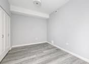 Thumbnail 34 of 69 - A room with a grey floor and white walls.