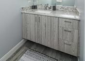 Thumbnail 60 of 69 - A bathroom with a vanity and a mirror.