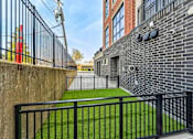 Thumbnail 513 of 885 - A black metal fence surrounds a green lawn.