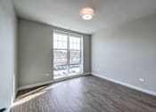 Thumbnail 753 of 885 - A room with a window overlooking a parking lot.