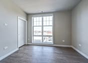 Thumbnail 793 of 885 - A room with a large window and a view of the city.