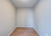 Thumbnail 798 of 885 - A room with wooden flooring and white walls.