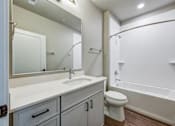 Thumbnail 808 of 885 - A white bathroom with a sink, toilet, and bathtub.