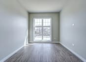 Thumbnail 833 of 885 - A room with a large window and wooden flooring.