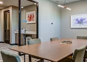 Thumbnail 848 of 885 - A conference room with a long table and chairs.