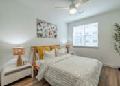 Thumbnail 9 of 9 - A bedroom with a large bed and a ceiling fan.