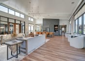 Thumbnail 27 of 36 - a large lobby with couches tables and chairs and large windows at Statesman Apartments, Franklin