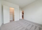 Thumbnail 31 of 36 - a living room with carpet and a door to a closet at Statesman Apartments, Franklin, 53132