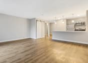 Thumbnail 17 of 28 - an empty living room and kitchen with wood flooring at Park 44, St. Louis, MO, 63108