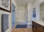 Thumbnail 18 of 36 - a bathroom with a shower toilet and sink and a mirror at Statesman Apartments, Franklin