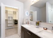 Thumbnail 33 of 52 - a kitchen with a white counter top and a window at Aster Apartments, Beachwood, OH