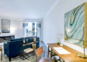 Thumbnail 30 of 52 - a living room with a blue couch and a fireplace at Aster Apartments, Ohio