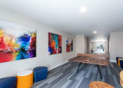 Thumbnail 35 of 52 - a conference room with a table and paintings on the wall at Aster Apartments, Beachwood, 44122