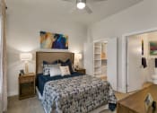 Thumbnail 9 of 52 - a bedroom with a bed and a ceiling fan at Aster Apartments, Beachwood