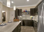 Thumbnail 40 of 52 - a kitchen with stainless steel appliances and a counter top at Aster Apartments, Ohio