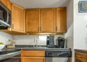 Thumbnail 21 of 28 - a kitchen with stainless steel appliances and wooden cabinets at Park 44, St. Louis, 63108