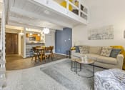 Thumbnail 3 of 28 - a living room with a couch and a table and a kitchen at Park 44, Missouri, 63108
