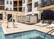 Thumbnail 10 of 22 - Resort style pool deck with cabanas at Timber Club Apartments, St. Peters, MO